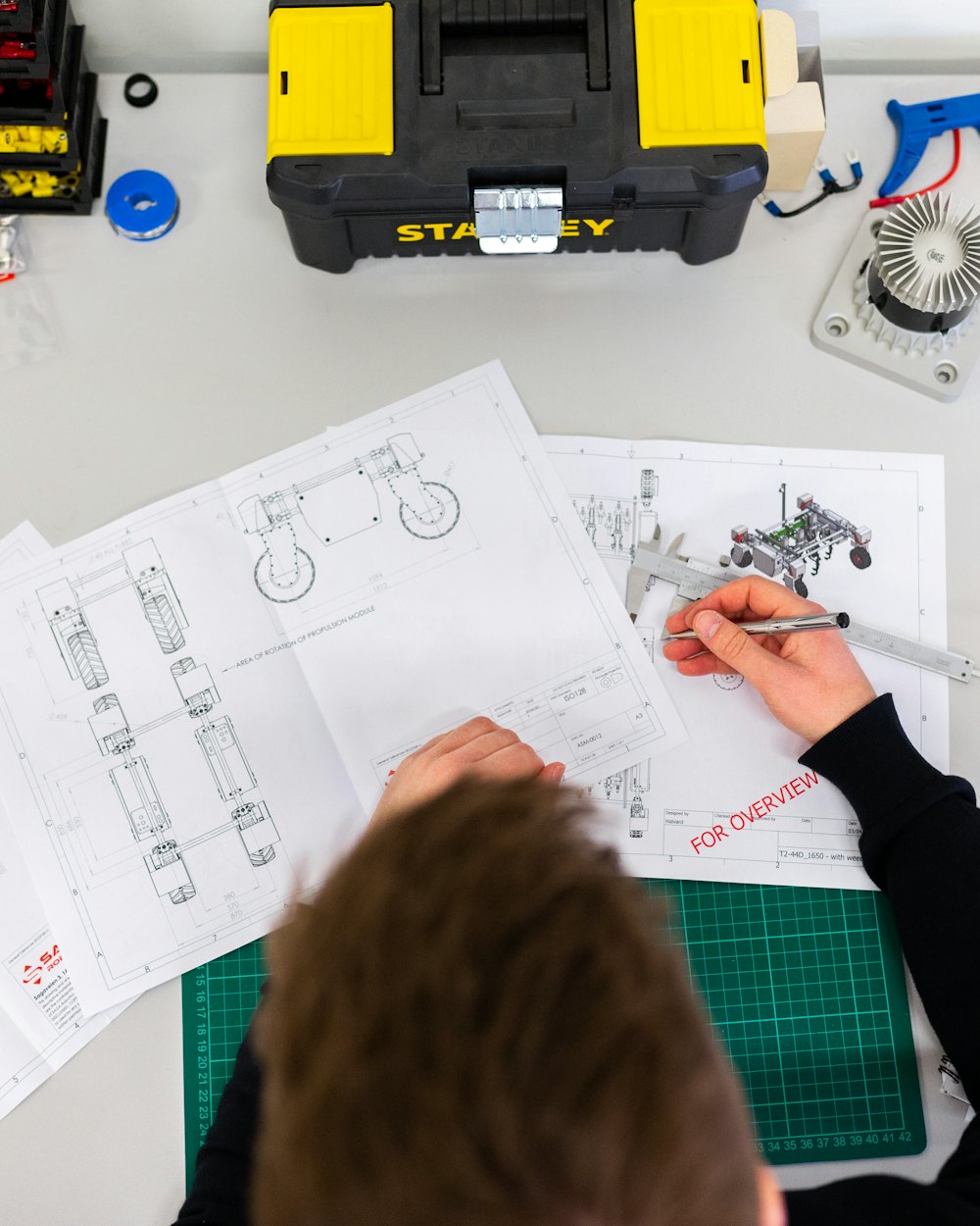 Detailed design drawings on a workbench